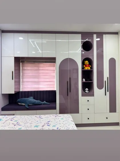 This multifunctional unit for a kids' room combines a wardrobe, drawers, display niches, and a window seat with storage underneath.