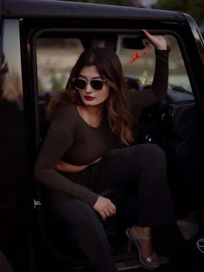 A duplicate of image 159, this moody portrait of a model in a car has a cinematic and story-driven quality.