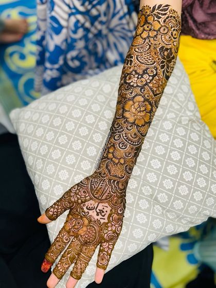 A stunning bridal floral design with full coverage. The groom's name is beautifully incorporated into the palm.