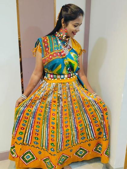 The full flare of this colourful ghagra is perfect for twirling. You'll definitely stand out in this outfit.