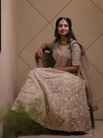 A full view of a stunning reception lehenga look. I focused on creating a luminous makeup style that complemented the intricate silver embroidery of her outfit.