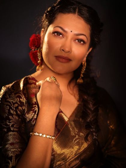 A powerful and confident pose from Priyanka Barve's retro-themed shoot, highlighting the rich gold saree and traditional jewelry.