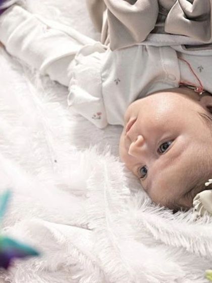 An awake and curious baby looking up at the camera. Capturing their beautiful eyes is just as important as the sleepy poses.