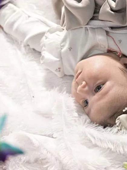 An awake and curious baby looking up at the camera. Capturing their beautiful eyes is just as important as the sleepy poses.