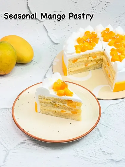 A slice of pure summer, our Seasonal Mango Pastry is light, airy, and layered with fresh mango cream and chunks. It's the perfect way to enjoy the authentic taste of the season in a classic pastry form.