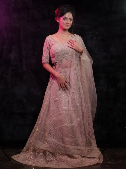 This pose captures the elegance of the outfit and the radiant glow of the makeup.