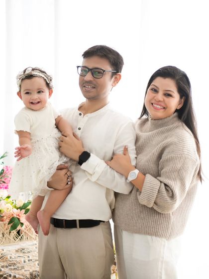 A classic family portrait in neutral tones. This timeless style ensures that your family photos will be cherished for generations to come.