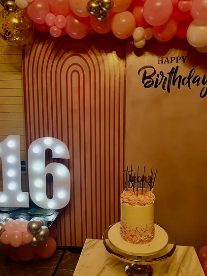 The birthday cake and decor for a sweet sixteen, where our catering services complemented the chic and celebratory atmosphere.