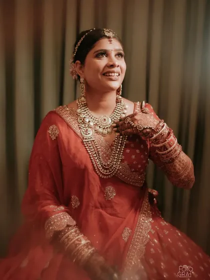 A beautiful candid moment of bride Pooja. Her smile and the soft glow of her makeup truly capture the joy of the wedding day.