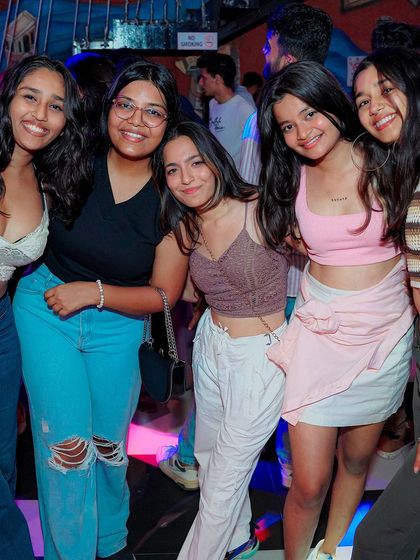 A group of friends posing for a photo on the dance floor. My gigs are a place to connect and make memories.