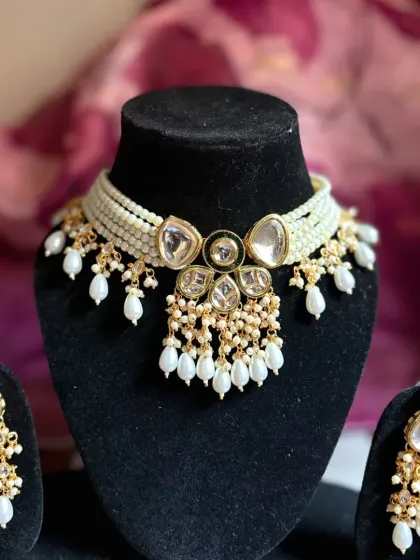A beautiful Kundan and pearl choker set. The large uncut Kundan stones combined with multiple layers of pearls create a look of pure elegance.