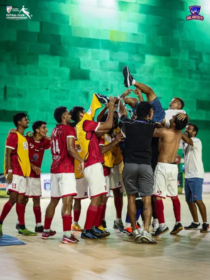 Lifting our coach in the air. A celebration for the man who guided us to victory.