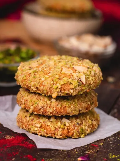 A stack of delicious, nut-crusted tikkis or kebabs, showcasing the texture and richness of our vegetarian appetizers.