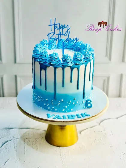 Another angle of the beautiful blue ombre sprinkle drip cake, showing off the rich color and clean lines.