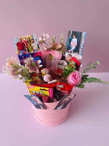 A full view of the round pink birthday box, overflowing with flowers, photos, and goodies. It’s a gift designed to make someone feel truly special.