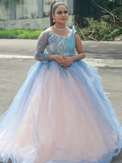 This blue and peach gown is paired with a soft, complementary makeup look, demonstrating a student's understanding of color harmony.