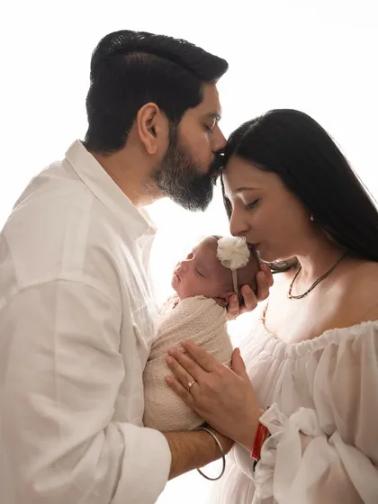 There is such a profound calmness in the love for a newborn. This is a moment from a bright and airy studio newborn session, where I focus on capturing the gentle, intimate connection between new parents and their baby.