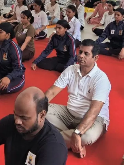 Faculty members and students meditating together during our college outreach program. Yoga brings a sense of unity and shared purpose to any community.