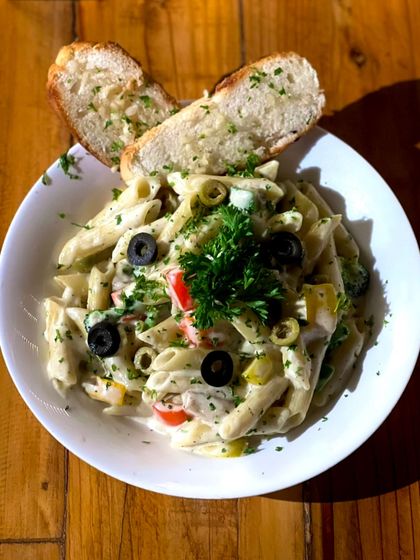 A classic comfort dish. Our creamy Alfredo penne pasta is loaded with fresh veggies and served with a side of garlic bread.