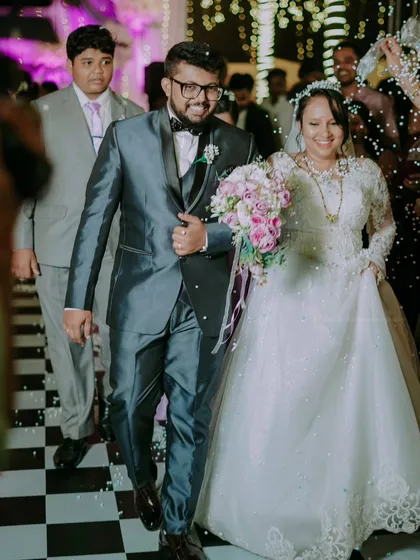 The grand entrance at the reception, with guests showering the happy couple with confetti.