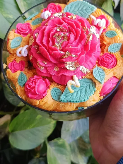 A close-up of the side of the rose garden candle.