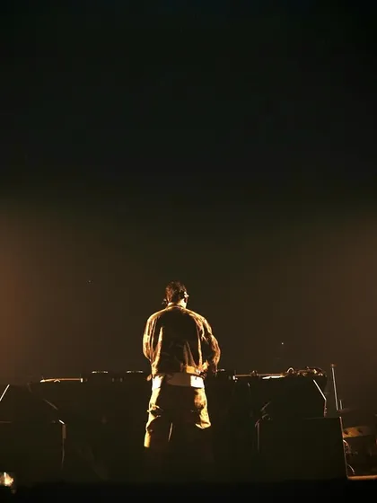 A solitary moment behind the decks at Quake, preparing for the next track in a haze of stage smoke.