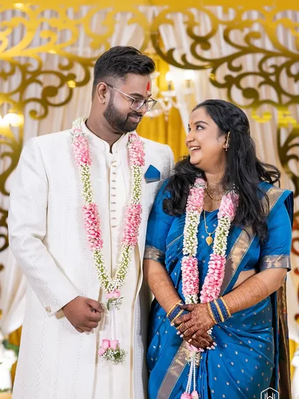 A beautiful couple portrait after their ceremony. The groom's grooming in his light-colored sherwani is minimal and clean, focusing on a fresh and bright appearance.