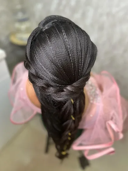 An overhead shot that gives a clear view of the detailed braiding work at the top of the hairstyle.