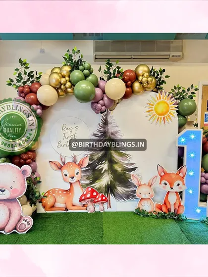 I designed this enchanting woodland creatures theme for a first birthday party. The setup features adorable cutouts of a bear, deer, fox, and rabbit against a forest backdrop, with a large light-up number '1' and earthy-toned balloons.