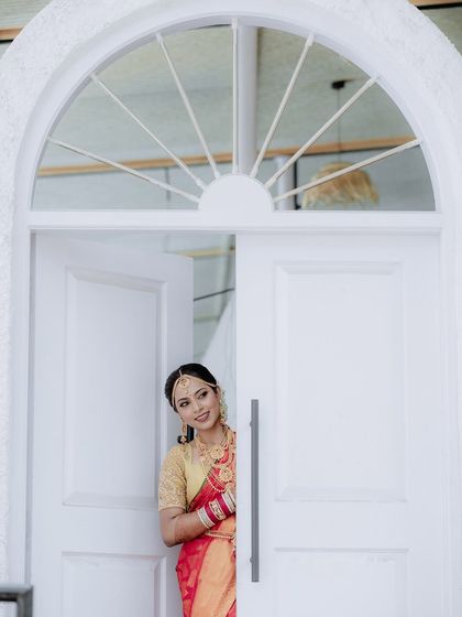 Another shot of the bride by the door, this time with a wider view. This pose is great for creating a narrative of the bride waiting for her groom.