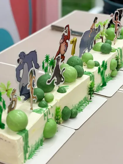 Indulge in this jungle-themed long cake. Inspired by The Jungle Book, this cake is a wild adventure of flavor, perfect for a first birthday party.