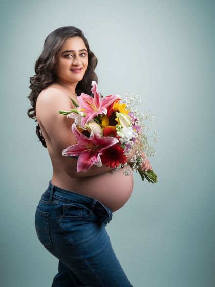 Petals of love. This intimate moment showcases the beauty of motherhood and the intimacy of this special time with a touch of boudoir elegance.