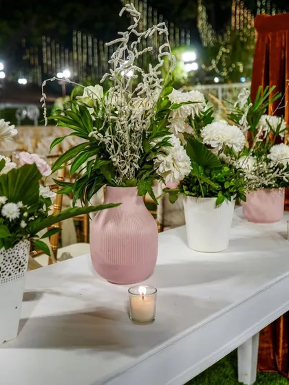 It's the small touches that count. A simple centerpiece with fresh flowers and a candle can add a touch of warmth and elegance to your event tables.