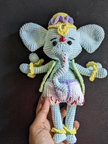 A full-length view of the light-blue Ganesha doll.