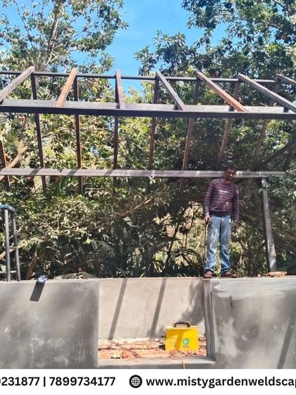 A front-on view of the cow shed frame under construction. This shows the sturdy base and the carefully crafted roof trusses that will support the final structure.