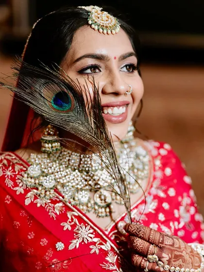 Draped in tradition, glowing with love. This bridal look is all heart, from the red lehenga to the soft glam and timeless jewels.