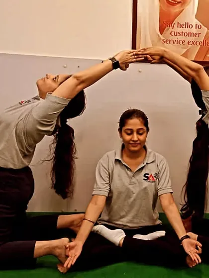A creative group pose at the end of a corporate session. It's a great way to build team spirit and have some fun after the practice.