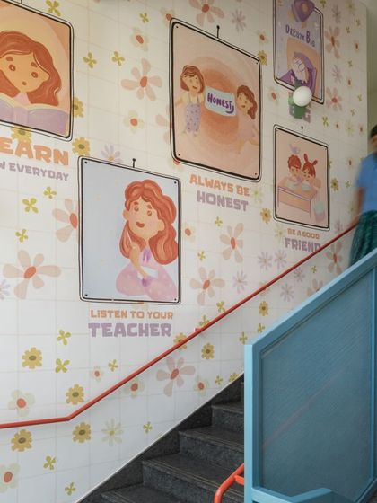 This stairwell is lined with custom tiles featuring illustrations and messages that reinforce good values like "Listen to your teacher" and "Be a good friend." It's a constant, gentle reminder of the school's community ethos.