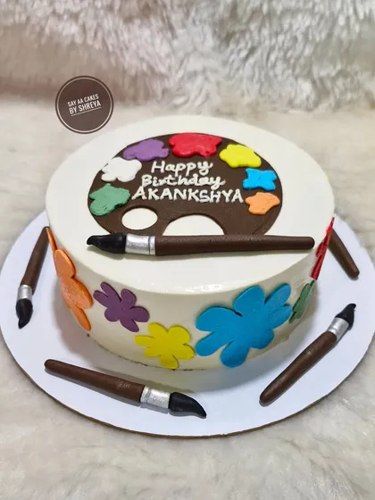 A palette of flavors for the artist at heart. This cake is decorated to look like an artist's palette with dabs of colorful frosting, surrounded by edible paintbrushes made from fondant.