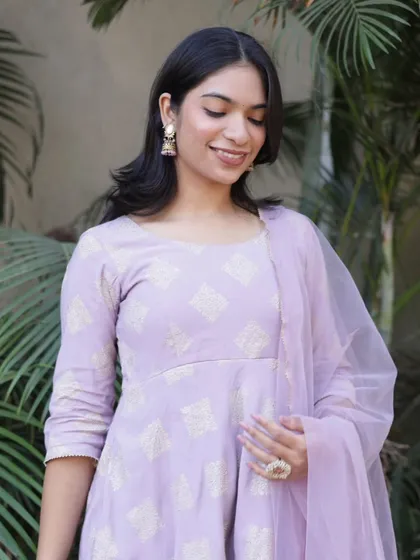 A serene portrait showcasing a lavender Anarkali, with a focus on the delicate fabric and the model's gentle expression.