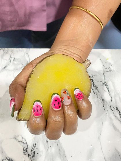 Fun, hand-painted watermelon nail art. This design shows the student's ability to create detailed, thematic art that is perfect for a summery, playful look.