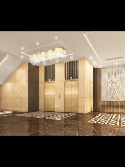 A render of the luxurious entrance lobby for 'The Legacy', a premium residential tower in Nagpur. The design features a grand staircase, marble-clad walls, and crystal chandeliers to create an unforgettable first impression.