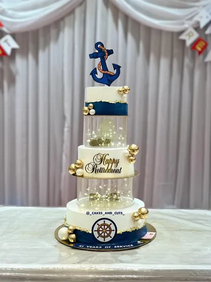 The retirement cake set against the party backdrop, ready for the celebration.