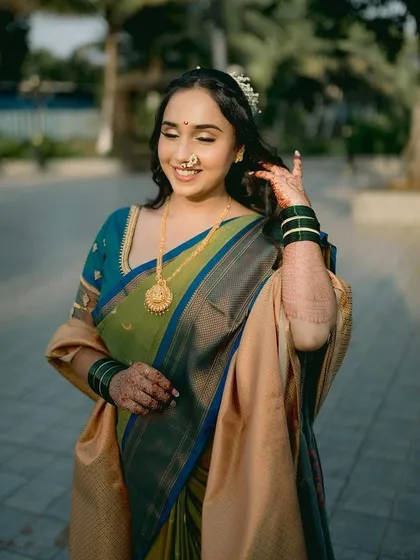 A lovely shot of my engagement bride. Her natural, happy glow is enhanced with soft makeup, a classic nath, and traditional green bangles, creating a perfect look for the occasion.
