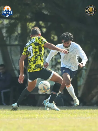 A tense moment on the pitch as our player tries to dispossess an opponent.