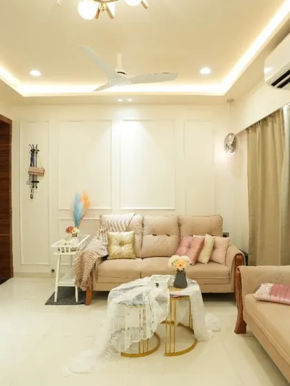 Showcasing our love for minimalist luxury. This living room uses a palette of soft whites and beiges, elegant wall moulding, and warm lighting to create a serene and sophisticated atmosphere.