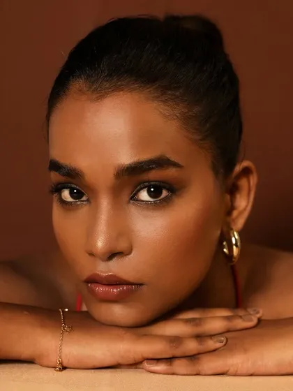 Flawless skin is an art. This close-up on a beautiful brown skin tone showcases a seamless, filter-free foundation blend that looks and feels like real skin.