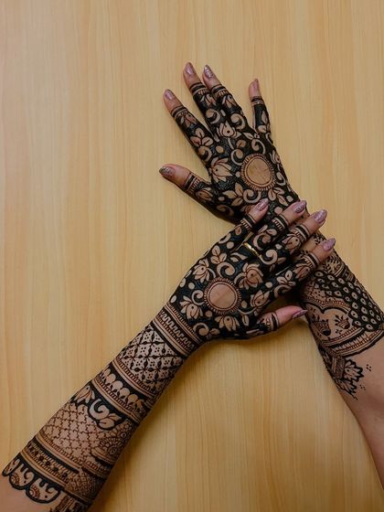 A focus on the back-hand design, which is just as important as the front. This features floral mandalas and dense geometric patterns on the arms.