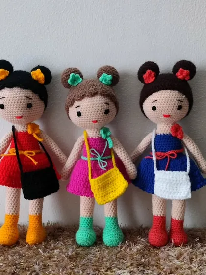 A trio of friends, each with a different colored dress and bag. They are so bright and cheerful.