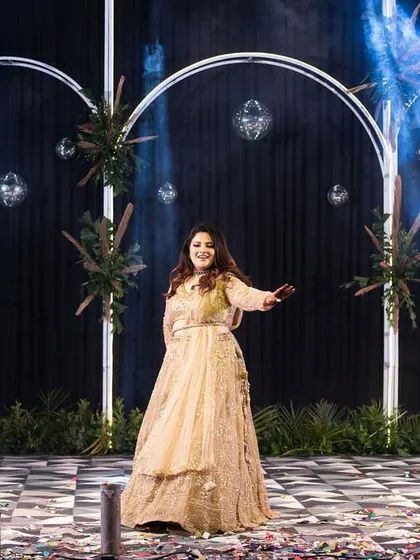 The stage is all yours. This shot captures the bride owning the stage during her solo performance, showcasing her confidence and the graceful choreography we prepared together.